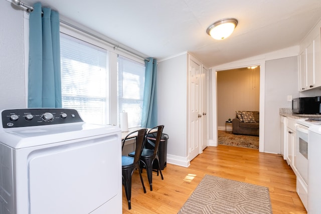 laundry area featuring light hardwood / wood-style flooring and washer / clothes dryer