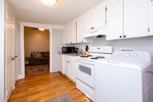 kitchen with washer / dryer, sink, white appliances, light wood-type flooring, and white cabinets