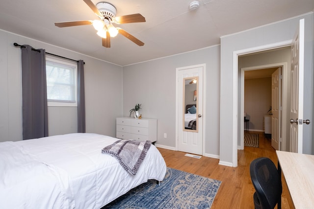 bedroom with ceiling fan and light hardwood / wood-style floors