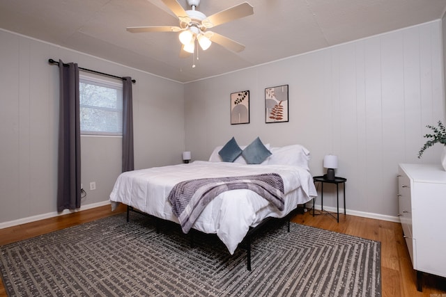 bedroom with ceiling fan and hardwood / wood-style flooring