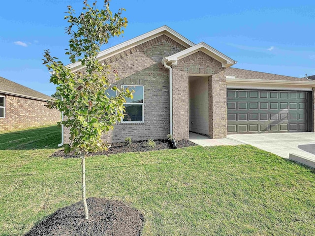 view of front of home with a front yard and a garage