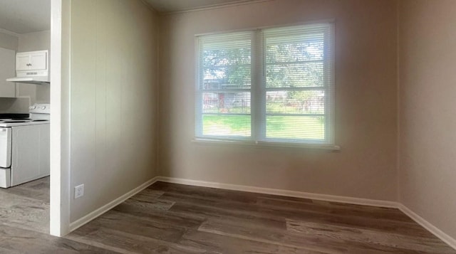 unfurnished dining area with dark hardwood / wood-style floors and ornamental molding