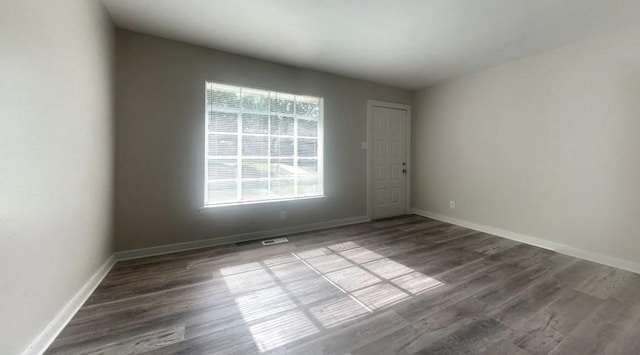 spare room with wood-type flooring