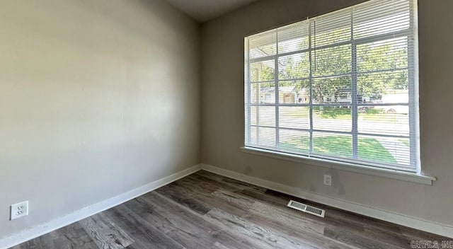 unfurnished room with plenty of natural light and hardwood / wood-style floors