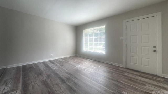 unfurnished room featuring dark hardwood / wood-style floors