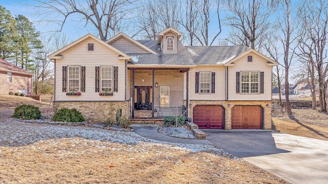 view of front of property featuring covered porch and a garage