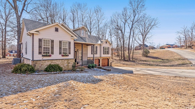 view of front of property featuring a garage and central air condition unit