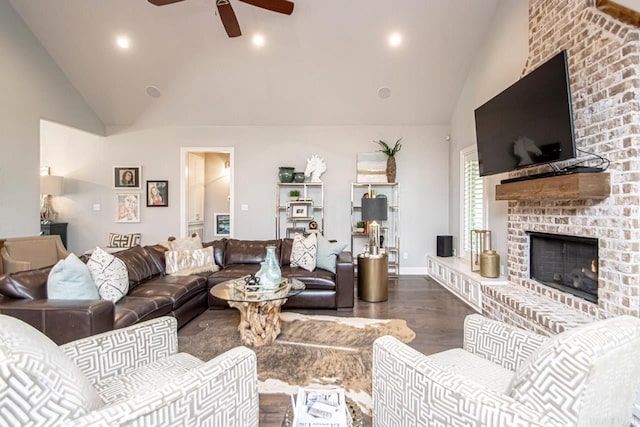 living room with a fireplace, high vaulted ceiling, ceiling fan, and dark hardwood / wood-style flooring