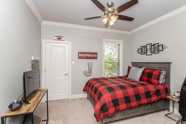 carpeted bedroom with ceiling fan and ornamental molding