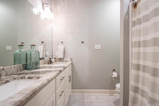 bathroom featuring toilet and vanity