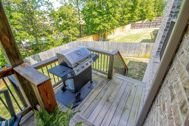 deck with a grill and a yard