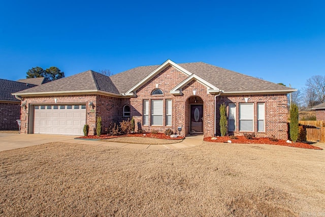 view of front of house featuring a front yard and a garage