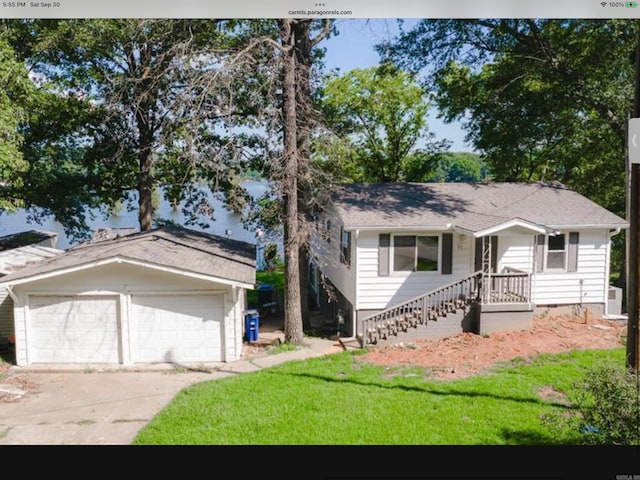 ranch-style house featuring a garage and a front lawn