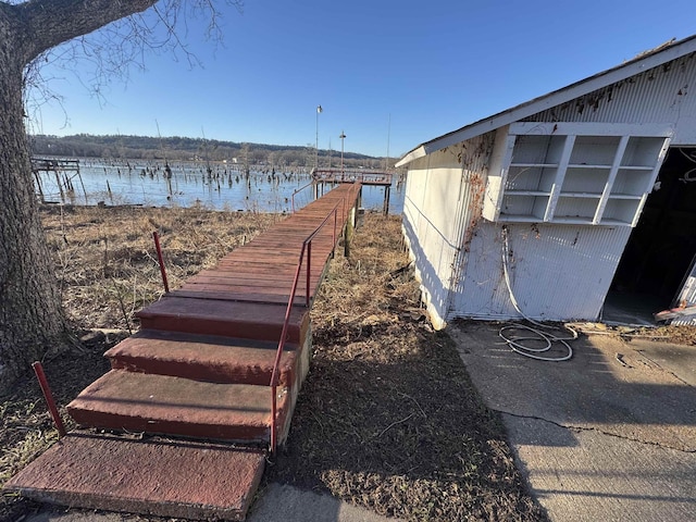 view of yard with a boat dock and a water view