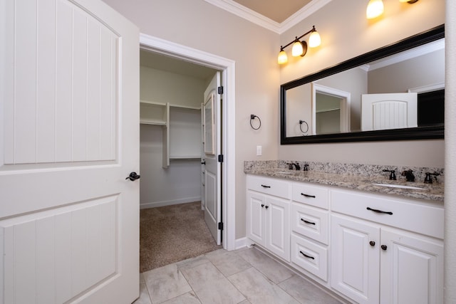 bathroom featuring crown molding and vanity