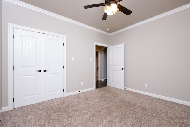 unfurnished bedroom with a closet, ceiling fan, carpet, and ornamental molding