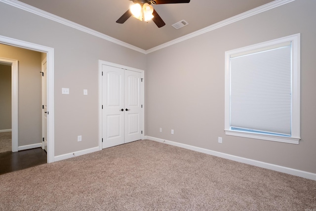 unfurnished bedroom featuring ceiling fan, carpet, a closet, and ornamental molding