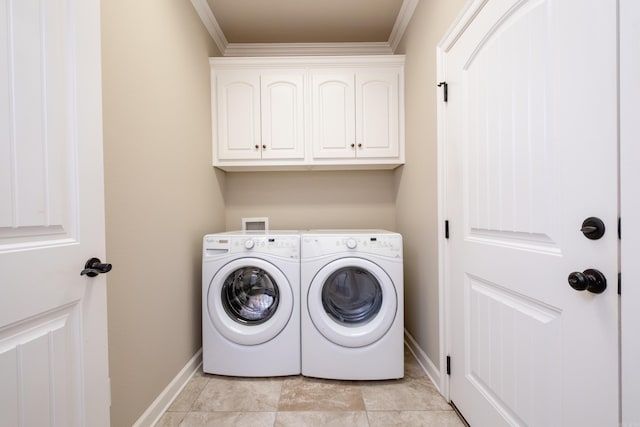 laundry area featuring crown molding, cabinets, and washer and dryer