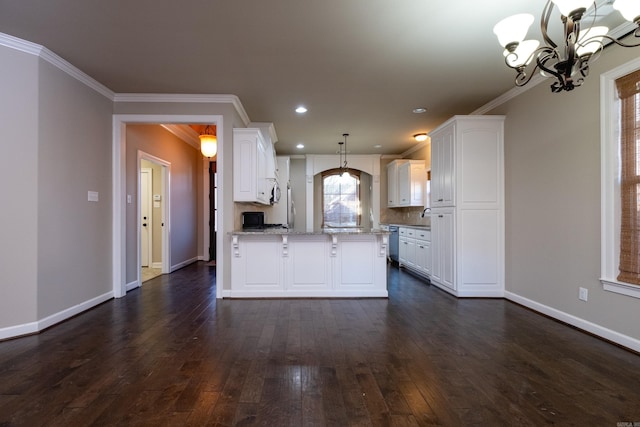 kitchen with crown molding, light stone countertops, white cabinets, decorative light fixtures, and an inviting chandelier