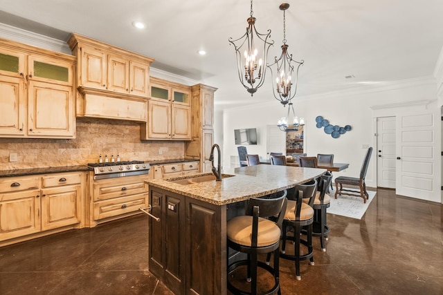 kitchen featuring light stone countertops, an island with sink, sink, hanging light fixtures, and ornamental molding