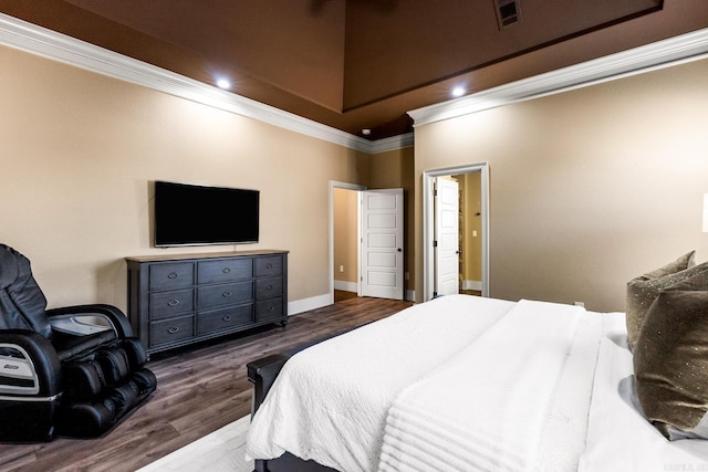 bedroom with crown molding and dark hardwood / wood-style flooring