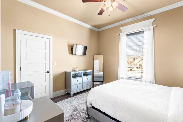 bedroom with ceiling fan, crown molding, and dark hardwood / wood-style flooring