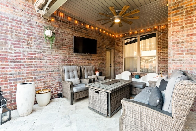 view of patio / terrace featuring ceiling fan and an outdoor living space with a fire pit