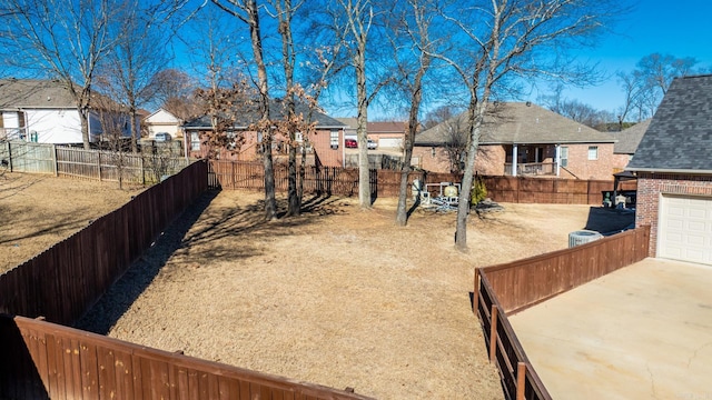 view of yard featuring a garage and cooling unit