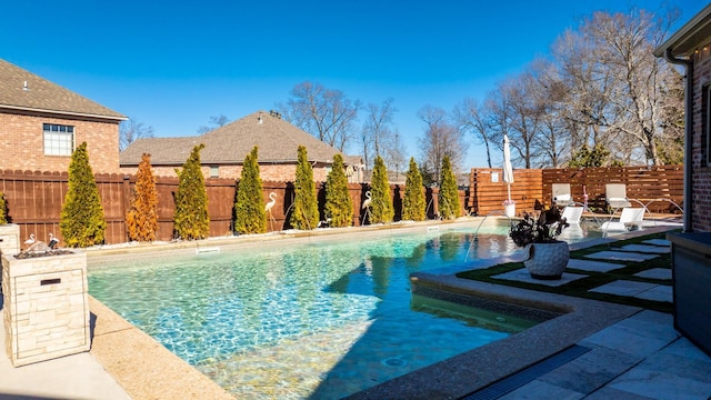 view of swimming pool featuring pool water feature and a patio