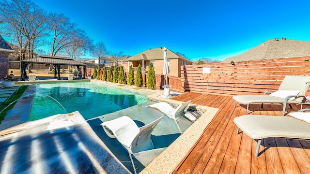 view of pool with a gazebo, a wooden deck, and pool water feature