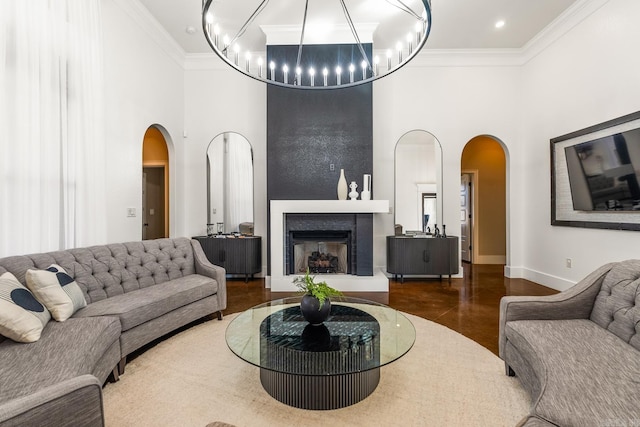 living room with a towering ceiling and crown molding