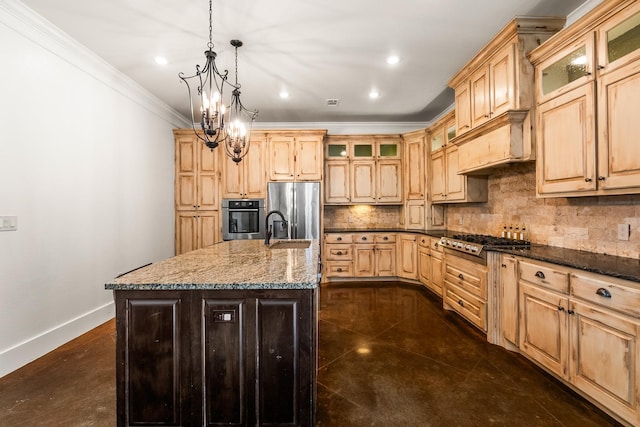 kitchen with stone counters, appliances with stainless steel finishes, decorative light fixtures, ornamental molding, and an island with sink