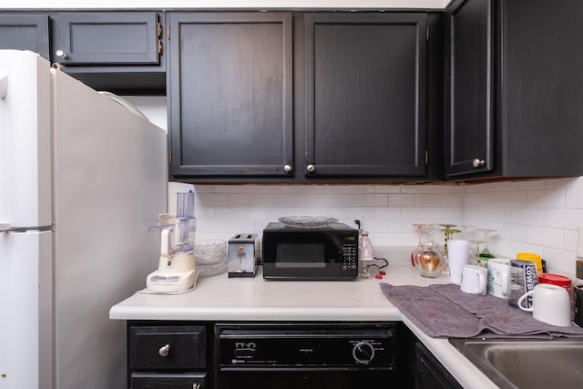 kitchen with black appliances and backsplash