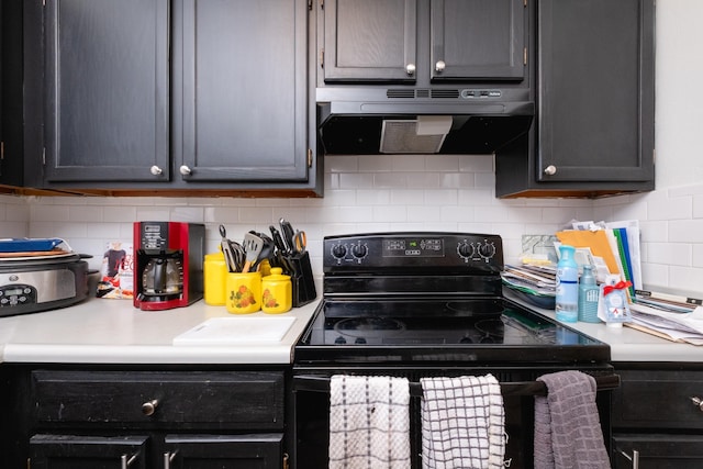 kitchen with electric range, extractor fan, and tasteful backsplash