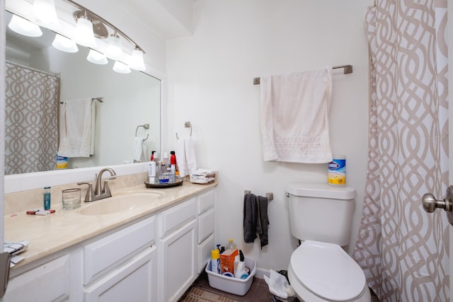 bathroom with toilet, vanity, and tile patterned flooring