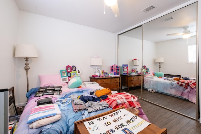 bedroom featuring a closet, ceiling fan, and dark wood-type flooring