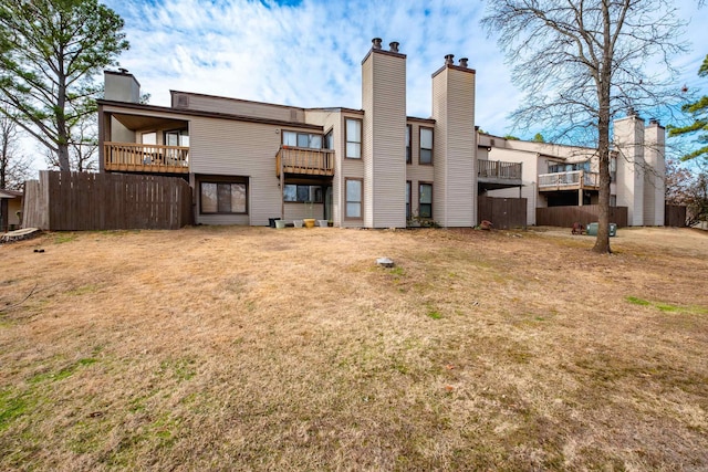 rear view of house featuring a yard