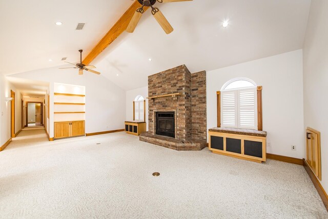 unfurnished living room featuring built in shelves, vaulted ceiling with beams, ceiling fan, a brick fireplace, and light colored carpet