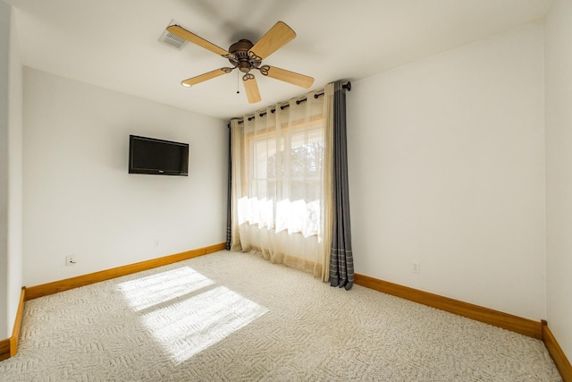 unfurnished room featuring ceiling fan and light carpet