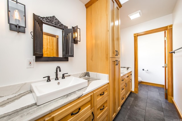 bathroom with toilet and vanity