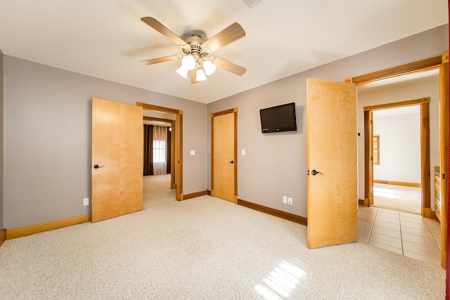 unfurnished bedroom with ceiling fan and carpet flooring