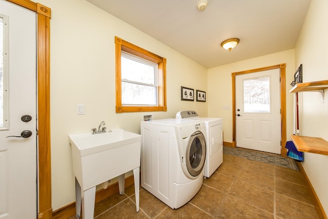 laundry room featuring a wealth of natural light and washer and dryer