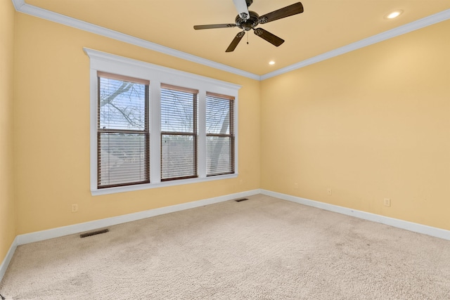 carpeted empty room with crown molding and ceiling fan