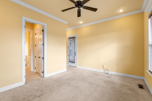 carpeted empty room with ceiling fan and ornamental molding