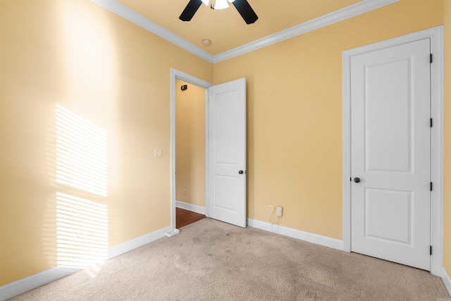 unfurnished bedroom with ornamental molding, ceiling fan, and light colored carpet