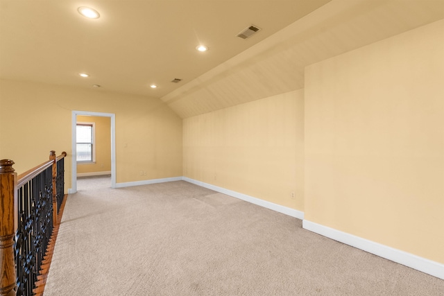 bonus room featuring light carpet and lofted ceiling