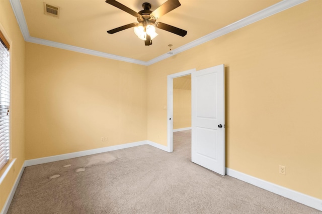 empty room with ceiling fan, light carpet, and crown molding