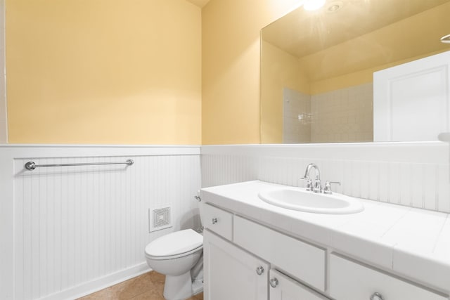 bathroom featuring vanity, toilet, and tile patterned floors