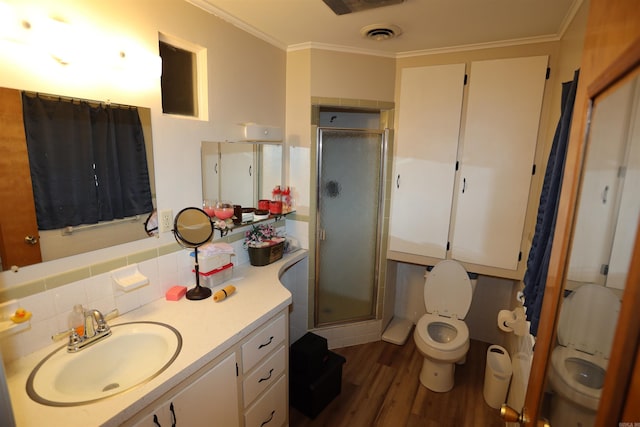 bathroom featuring crown molding, hardwood / wood-style flooring, an enclosed shower, and vanity