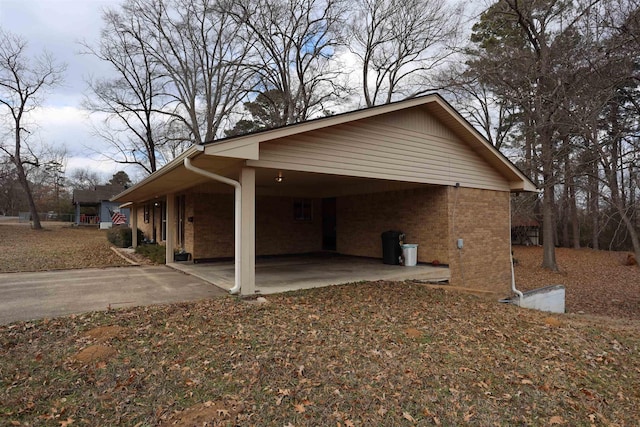 view of side of home with a carport